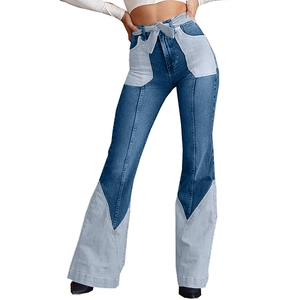 Detail of high waist contrast patchwork denim flare jeans with sash belt and wide leg