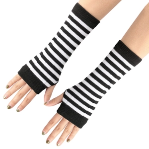 Close-up of black and white striped knitted arm warmers with thumb holes on model