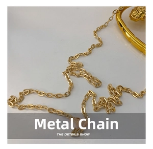 Close-up of elegant gold hardware chain with oval links for hard shell evening box bag