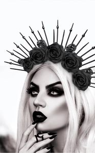 Gothic queen headband featuring black roses, tiny skulls, and radial spikes on a model