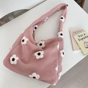 Dettaglio della borsa tote in peluche rosa con motivi floreali bianchi e soffice