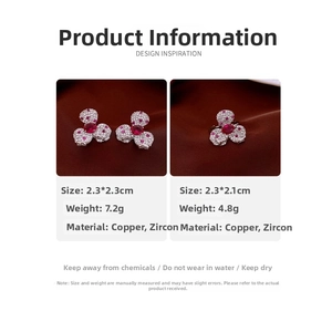 Detail view of flower earrings and ring set with red zircon stones on velvet