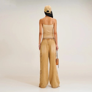 Women's vintage khaki cargo pants and crop top set shown from a stylish back view
