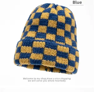 Close-up of blue and yellow checkerboard pattern on thick knitted winter beanie