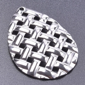 Detailed view of silver teardrop pendant featuring a textured woven finish and top loop