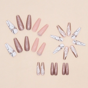 Long coffin false nails with champagne glitter marble patterns and crystal embellishments