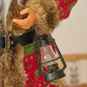 Standing Santa Claus doll in reindeer sweater with brown fur collar holding a vintage lantern