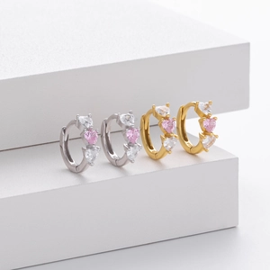 Detail of 925 sterling silver heart earrings with colorful zircon on geometric stand