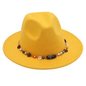 Close-up of yellow wool fedora hat featuring bohemian beaded band with floral charms