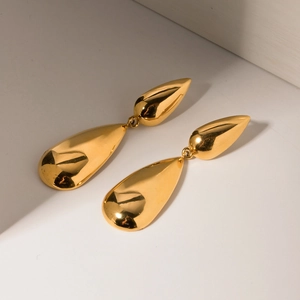 Minimalist double teardrop earrings in polished gold metal with a sleek reflective surface