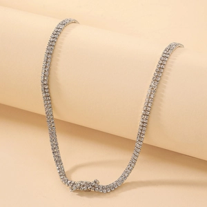 Detailed close-up of double-row pavé tennis necklace with sparkling silver crystal stones