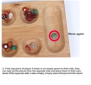 Macro shot of wooden Mancala board details with colorful glass stone pieces and game rules