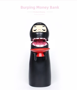 Detailed close-up of Kaonashi No-Face piggy bank with red coin tray and iconic mask