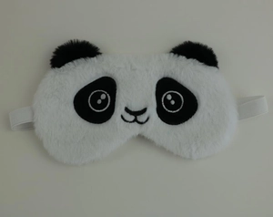 Close-up of soft plush panda sleeping eye mask with elastic strap on a flat background