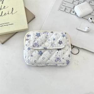 Detail of cute quilted organizer pouch with purple bear pattern and metal clip