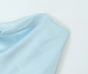Detail shot of light blue silky dress showing smooth fabric texture and seam stitches
