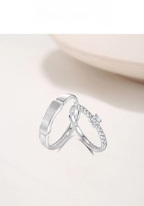 Close-up of S925 sterling silver couple rings featuring matte finish and sparkling pavé stones