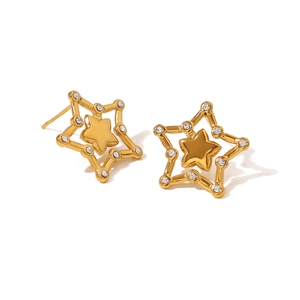 Macro view of gold star stud earrings with double-layered crystal-encrusted hollow design