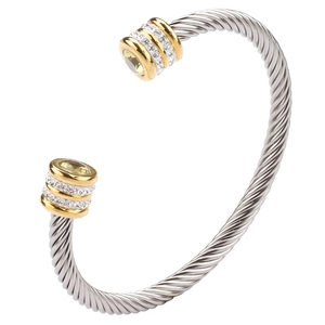 Macro detail of twisted cable cuff bracelet with crystal inlay and gold accents