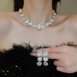 Elegant silver jewelry set with crystal flower necklace and matching drop earrings on model