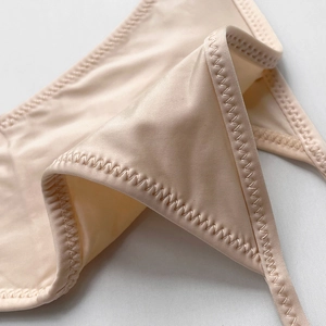 Close-up of champagne ice silk thong with premium glossy texture and stitching