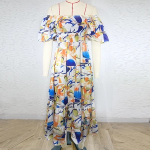 Detail of colorful abstract print and smocked off-shoulder bodice on a summer maxi dress
