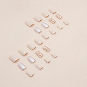Short square aurora press-on nails with daisy flower patterns in soft beige tones