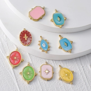 Macro view of colorful enamel eye pendants in gold stainless steel frames for jewelry