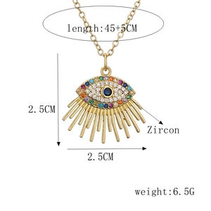 Detail view of gold evil eye pendant with blue zircon and size specifications