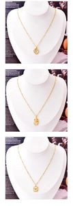Detail of vintage gold necklaces with shell heart, rose, and butterfly pendants