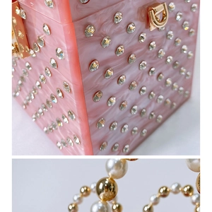 Close-up of pink marbled acrylic evening bag with sparkling rhinestones and pearl handle