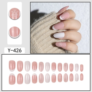 Pink and white French press-on nails with delicate winter snowflake patterns