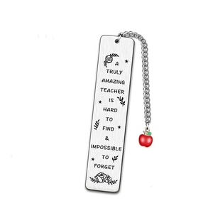 Macro shot of silver metal bookmark with red apple charm for teacher appreciation