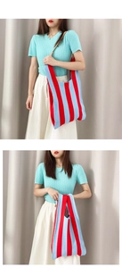 Detail of knitted tote bag with red and blue vertical stripes and soft texture