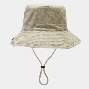 Detail of beige washed cotton sun hat featuring adjustable chin cord and stitched brim