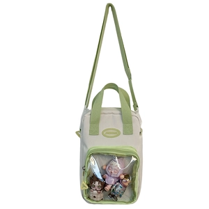 Detail view of the beige and green canvas ita bag showing the clear PVC window for charms