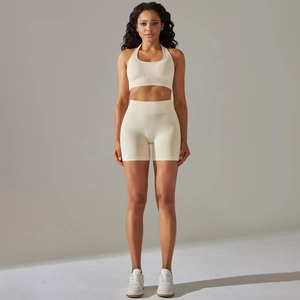Detail of off-white seamless ribbed yoga set featuring a halter bra and high-waist shorts