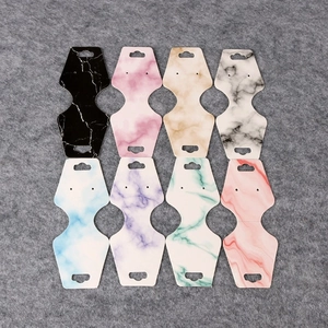 Detailed close-up of marble pattern jewelry display cards in various colors for earrings