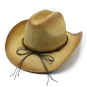 Detail of woven straw cowboy hat with black cord, metal beads and tassel accents