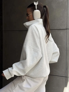 Detail view of oatmeal oversized half-zip sweatshirt with ribbed cuffs and drop shoulder