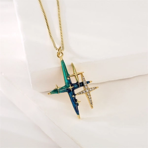 Close-up of golden celestial pendant with blue-green enamel and micro-pave zircons