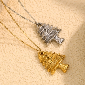 18K gold and silver plated stainless steel Christmas tree pendant necklaces on beige surface