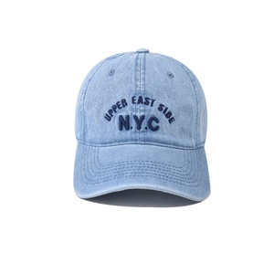 Detail of NYC letter embroidery on washed denim baseball cap with vintage finish