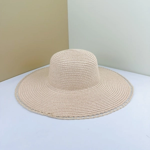 Women's wide brim straw sun hat with wavy edges for beach holidays and sun protection