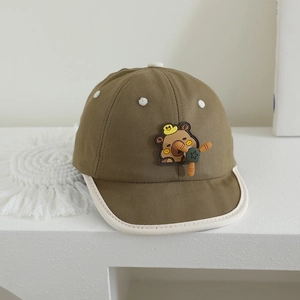 Detailed view of baby baseball cap featuring a cute cartoon bear and star propeller element