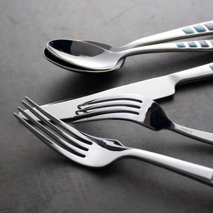 Polished stainless steel cutlery set with blue-green enamel geometric pattern handles