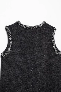 Detail of tweed sleeveless dress showing sparkly sequins and silver fringe trim