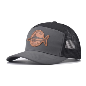 Detail of a dark gray trucker hat with fishing outdoors leather patch and mesh back