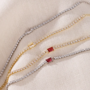 Close-up of elegant tennis bracelets featuring colorful rectangular cubic zirconia stones