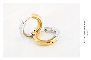 Macro shot of 4mm two-tone gold and silver polished stainless steel hoop earrings